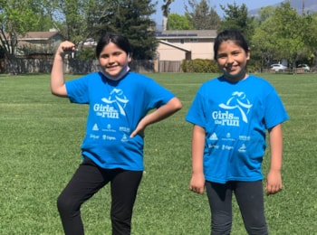 Two Girls on the Run participant both smile with an arm around each other